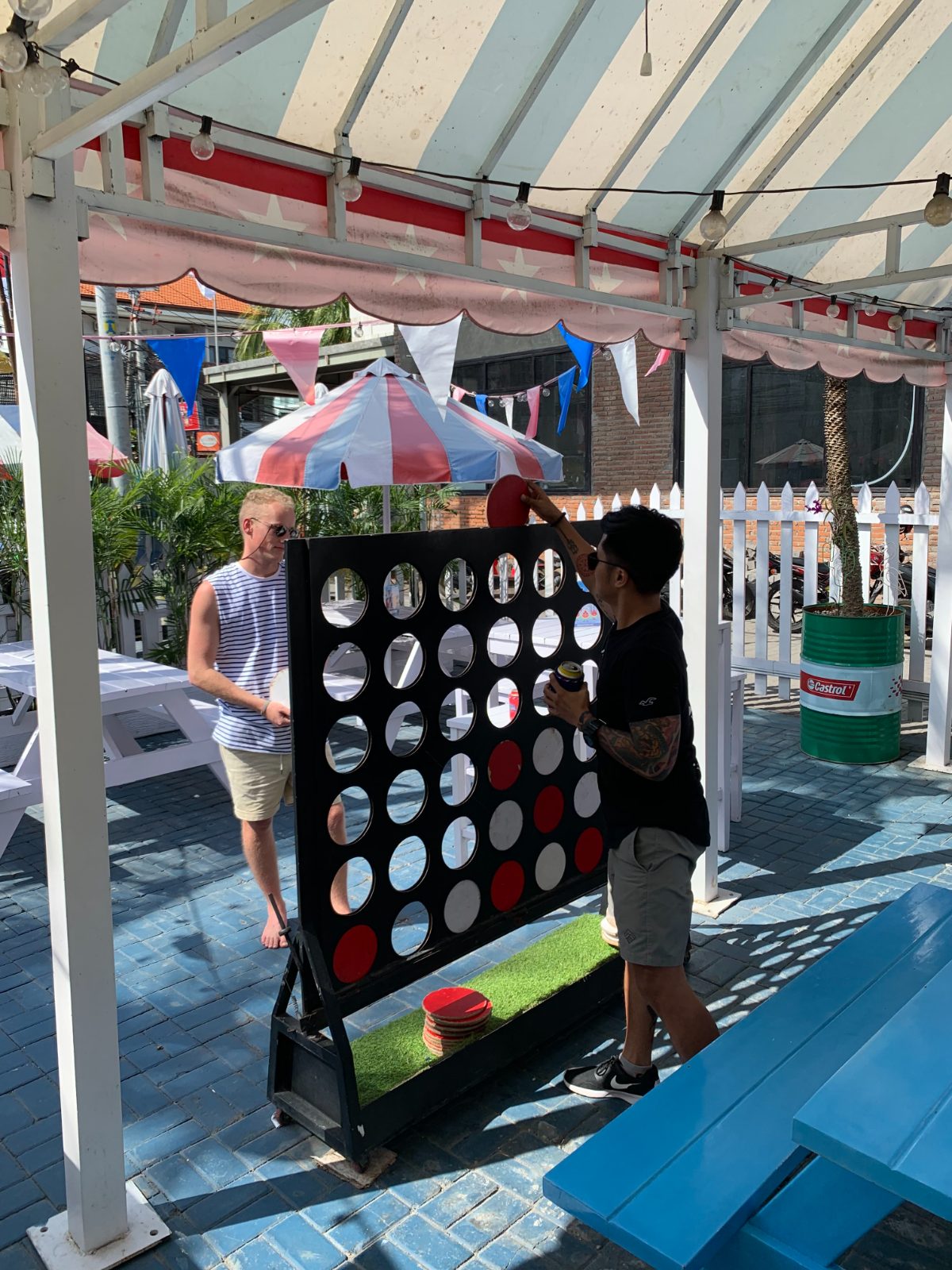 Two team members playing giant connect four at a retreat