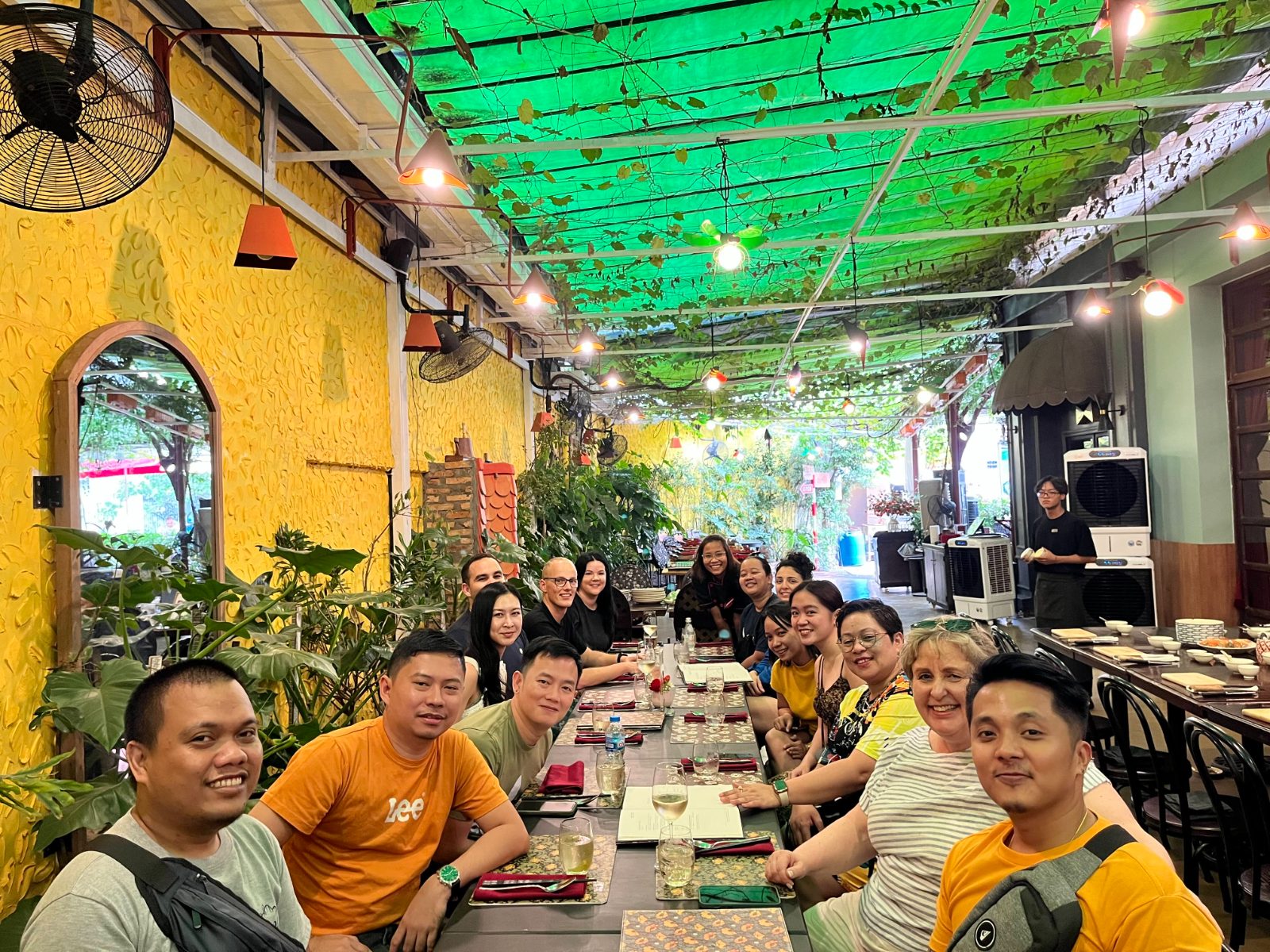 The FGS team around a long lunch table in Vietnam